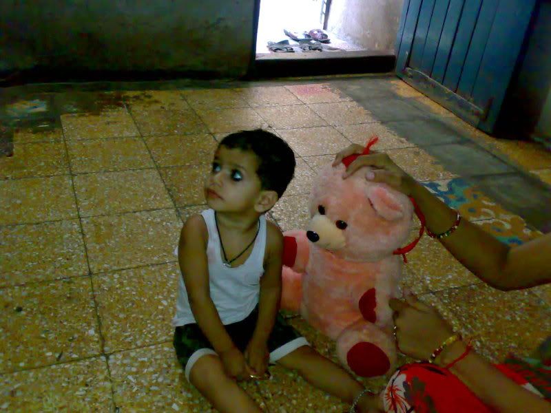 Cute baby playing with teddy